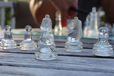 Close-up of glass chess pieces on table