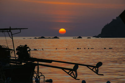 Silhouette people against sea during sunset