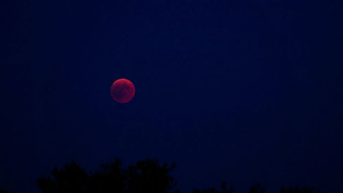 Low angle view of moon against sky at night