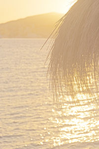 Close-up of sea against sky at sunset