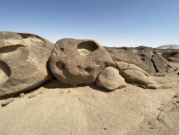 Rock formation on land against clear sky