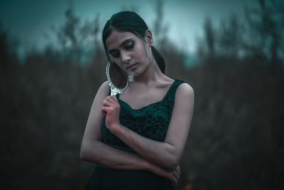 Portrait of woman standing outdoors