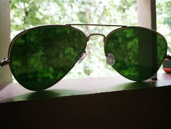 Close-up of sunglasses against sky