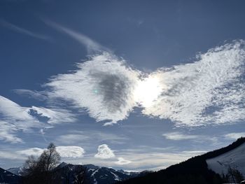 Low angle view of snowcapped mountains against sky