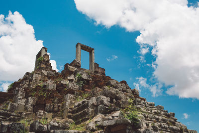 Low angle view of old building against cloudy sky