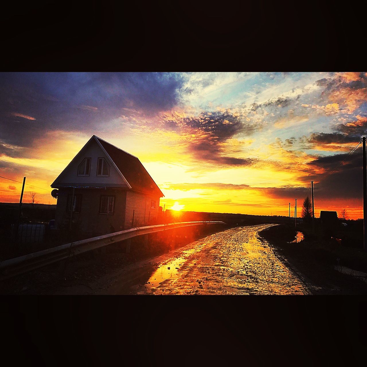 sunset, sky, orange color, silhouette, road, cloud - sky, dramatic sky, sun, scenics, no people, built structure, transportation, architecture, the way forward, landscape, nature, outdoors, tranquil scene, tranquility, beauty in nature, sunlight, building exterior, day