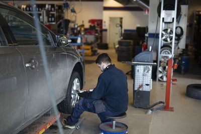 Man changing wheel in garage