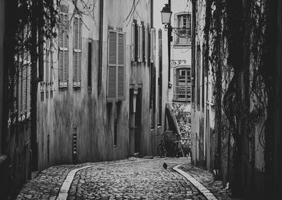 Narrow alley amidst old buildings in city