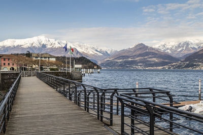 The lakeside promenade of colico with the snow-capped alps in the background