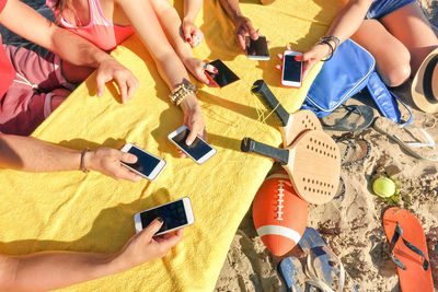 High angle view of people using smart phone at beach