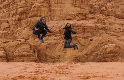 Full length of people on rock