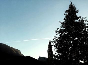 Low angle view of silhouette trees against clear sky