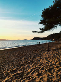 Scenic view of beach against sky during sunset