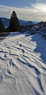 Scenic view of snow covered mountains against sky