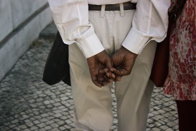 Midsection of couple walking on footpath