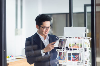 Businessman looking at photographs at office