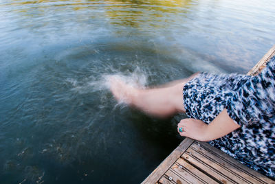 Low section of man on boat in lake