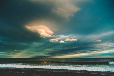 View of calm sea against cloudy sky