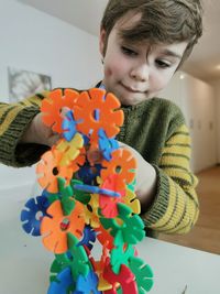 Portrait of boy with toy at home