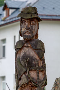 Close-up of statue against built structure