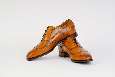 Close-up of shoes against white background