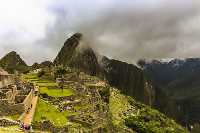 Scenic view of mountains against cloudy sky