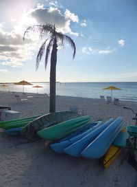 Scenic view of beach against cloudy sky