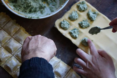 High angle view of man preparing food on table