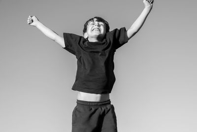 Portrait of boyl jumping against white background