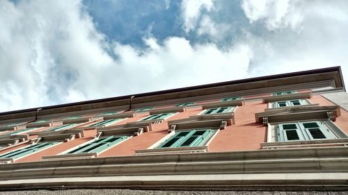 Low angle view of building against cloudy sky