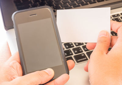 Close-up of man using mobile phone