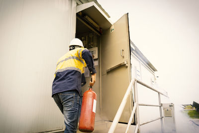 Rear view of man working at construction site