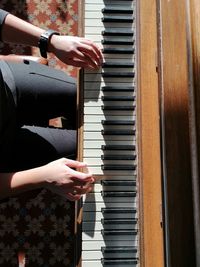 Close-up of woman playing piano