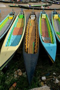 Multi colored boats moored in water