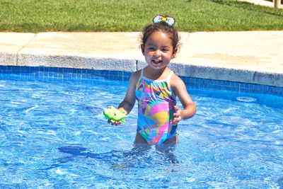Happy girl in swimming pool