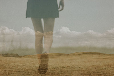 Low section of woman standing on field