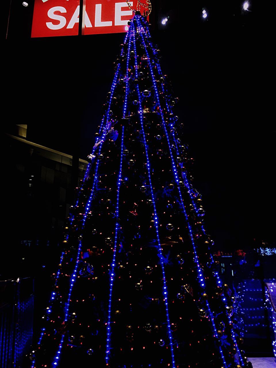 illuminated, night, building exterior, lighting equipment, built structure, celebration, architecture, long exposure, city, decoration, low angle view, glowing, motion, multi colored, light - natural phenomenon, christmas lights, light, sky, outdoors, no people