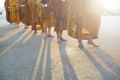 Low section of monks walking on road