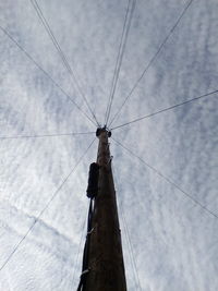 Low angle view of telephone pole against sky