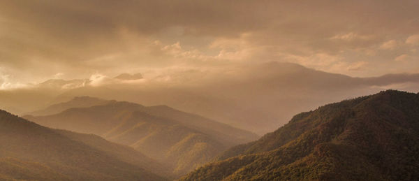 Scenic view of mountains against dramatic sky