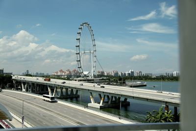 Cars on road against sky in city