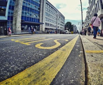 Surface level view of city street against sky