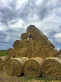 Rear view of woman standing on hay
