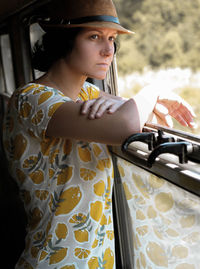 Thoughtful woman looking through window in vehicle