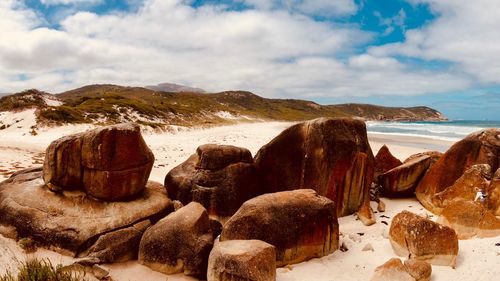 Panoramic view of rocks on beach against sky