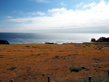 Scenic view of sea against cloudy sky