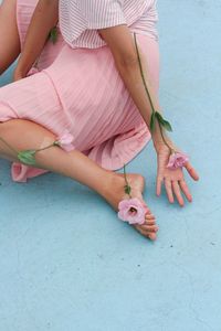 Low section of woman holding umbrella