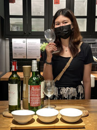 Side view of young woman standing in store