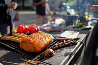 Fresh food grilling on barbecue against road