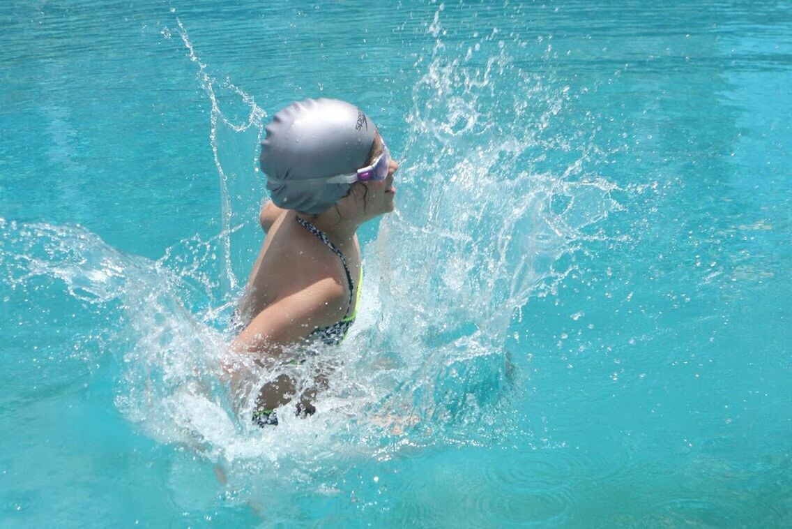 WOMAN IN SWIMMING POOL